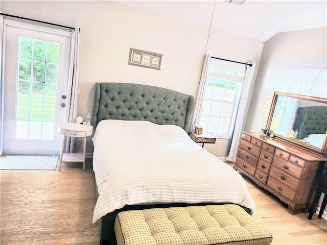3473 Newtons Crest Cir, Snellville, GA 30078 - bedroom with light wood-style flooring, access to exterior, and vaulted ceiling