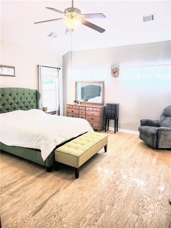 3473 Newtons Crest Cir, Snellville, GA 30078 - bedroom featuring wood finished floors and ceiling fan
