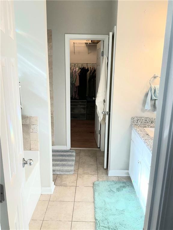 3473 Newtons Crest Cir, Snellville, GA 30078 - full bath with vanity, tile patterned floors, a spacious closet, and a bathtub