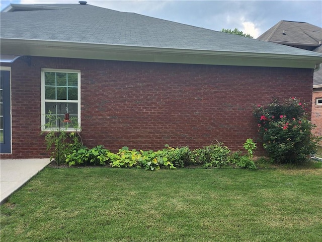 3473 Newtons Crest Cir, Snellville, GA 30078 - view of side of home with a lawn, brick siding, and roof with shingles