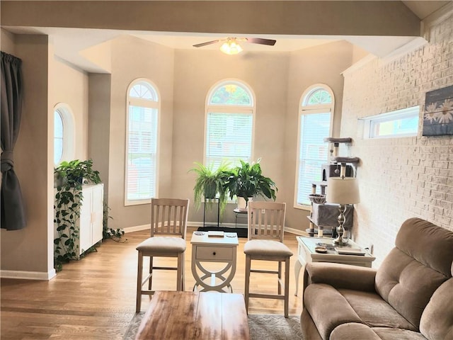 3473 Newtons Crest Cir, Snellville, GA 30078 - sitting room featuring healthy amount of natural light, a ceiling fan, wood finished floors, and brick wall
