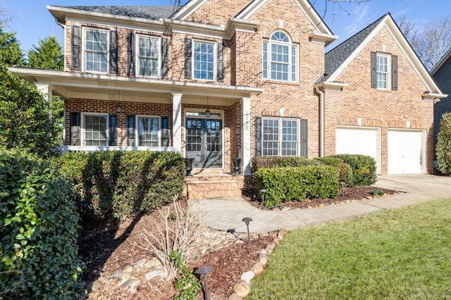 view of front of property featuring a garage, concrete driveway, and brick siding