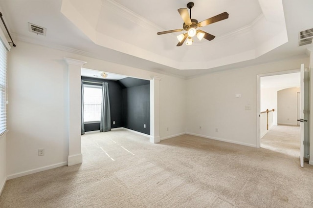 unfurnished room featuring a raised ceiling, visible vents, and light colored carpet