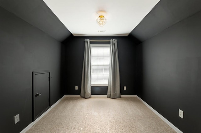 additional living space with lofted ceiling, carpet flooring, visible vents, and baseboards