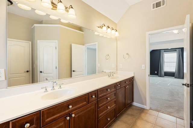 full bath featuring vaulted ceiling, double vanity, a sink, and visible vents