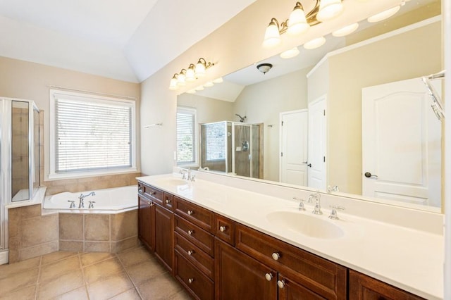 bathroom featuring lofted ceiling, a sink, a bath, and a shower stall