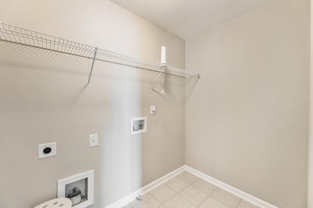 clothes washing area featuring light tile patterned floors, hookup for a washing machine, hookup for an electric dryer, laundry area, and baseboards