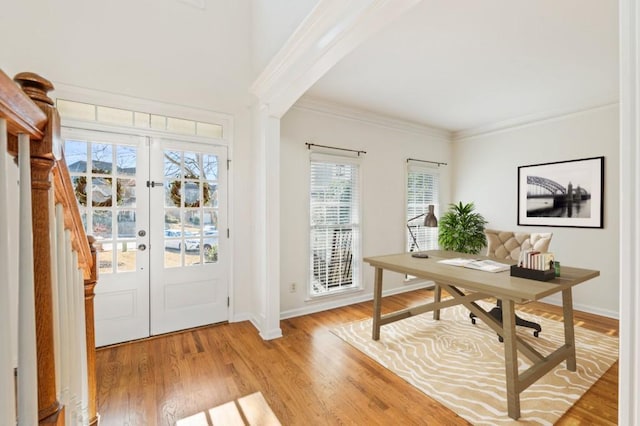 entryway featuring baseboards, french doors, light wood-style flooring, and crown molding