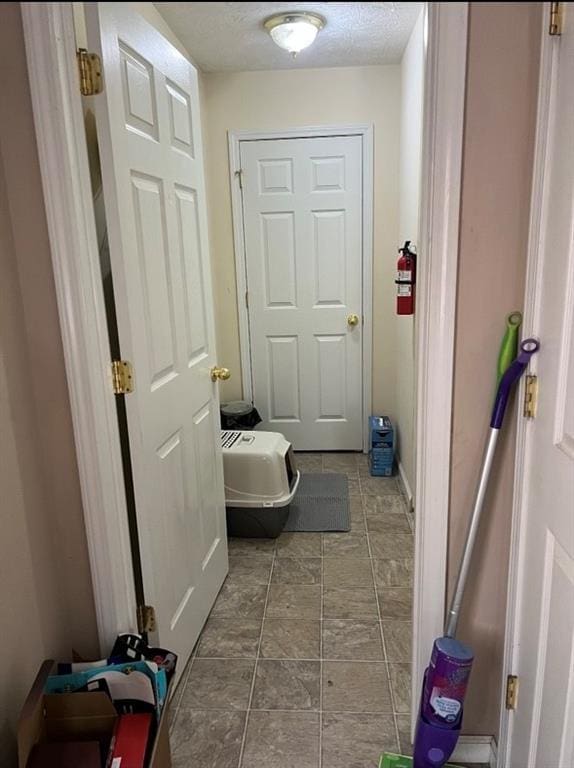 entryway with a textured ceiling