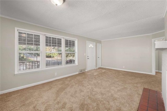 carpeted empty room with a textured ceiling and ornamental molding