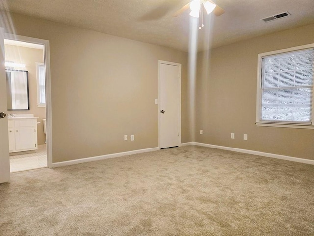 carpeted empty room featuring ceiling fan