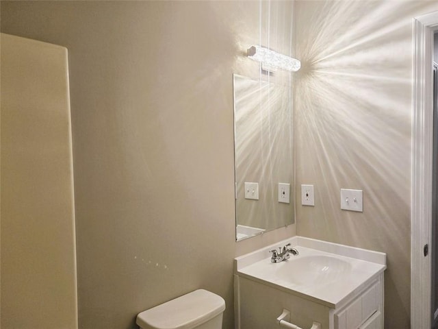 bathroom featuring toilet and vanity