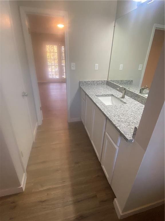 bathroom with vanity and wood-type flooring