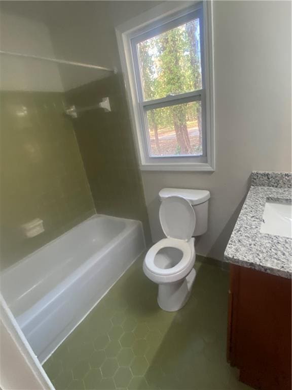 full bathroom featuring tile patterned floors, vanity, toilet, and shower / washtub combination