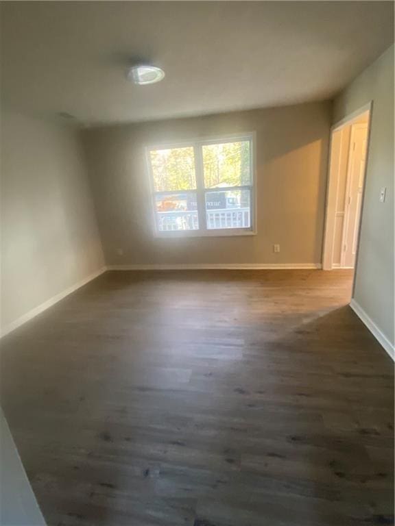 unfurnished room with dark hardwood / wood-style floors