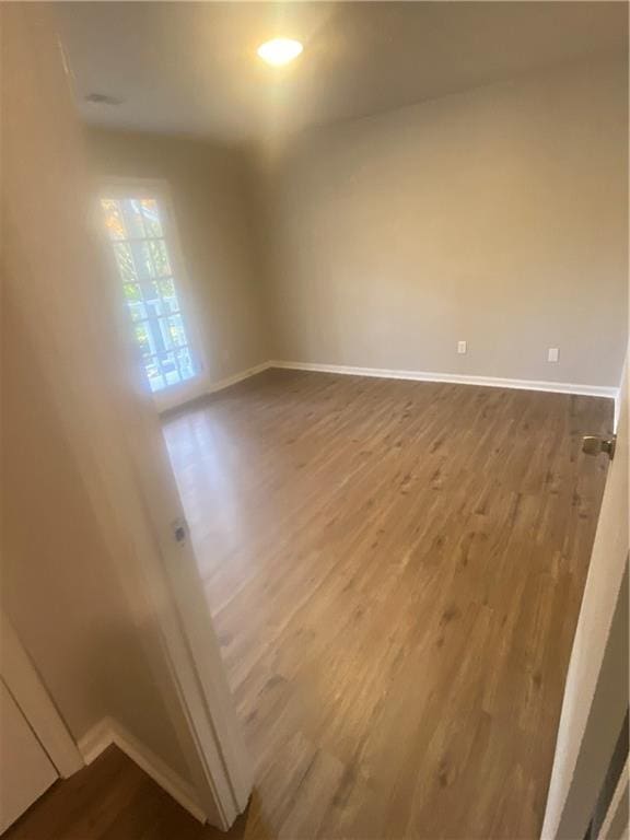 spare room featuring wood-type flooring