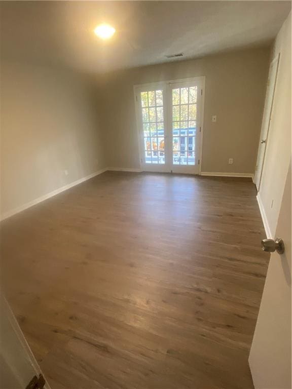 unfurnished room with dark hardwood / wood-style floors