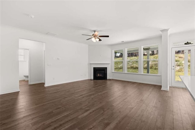 unfurnished living room with dark wood-type flooring and ceiling fan