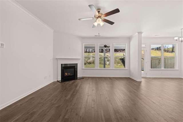 unfurnished living room with crown molding, ceiling fan with notable chandelier, and dark hardwood / wood-style flooring