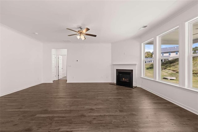 unfurnished living room featuring crown molding, ceiling fan, and dark hardwood / wood-style flooring