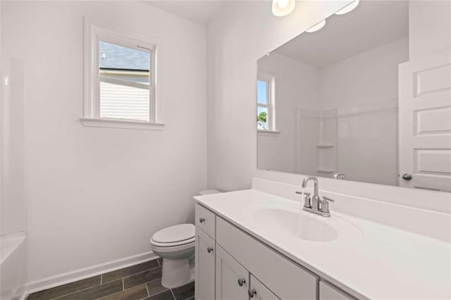 full bathroom with a healthy amount of sunlight, vanity, separate shower and tub, and toilet