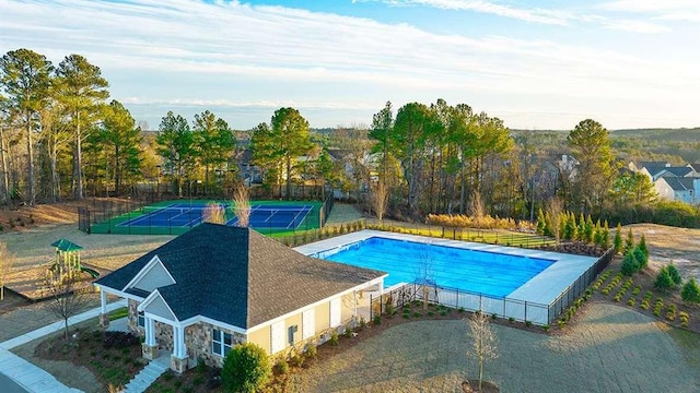 view of swimming pool featuring tennis court