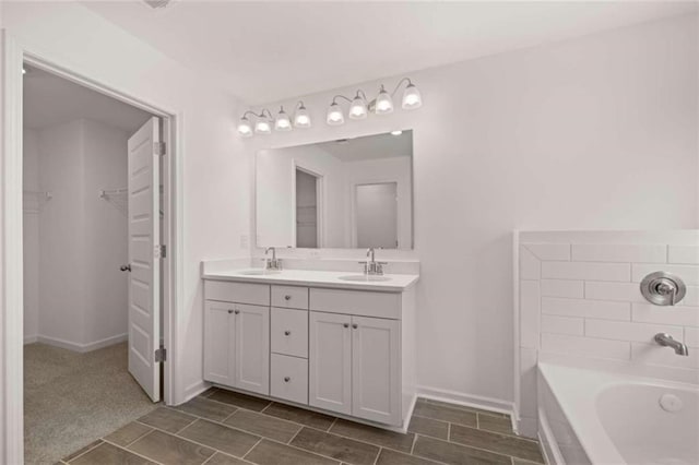 bathroom with vanity and a washtub