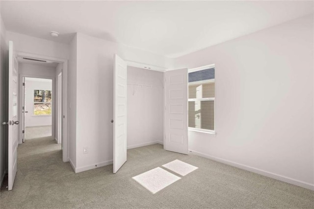 unfurnished bedroom featuring a closet and light colored carpet