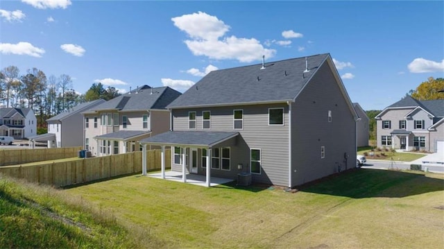 back of property with a patio, central AC unit, and a lawn