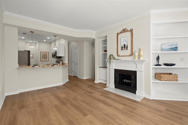 1024 Whitshire Way, Alpharetta, GA 30004 - living room with built in features, light wood-style flooring, ornamental molding, and a fireplace with flush hearth