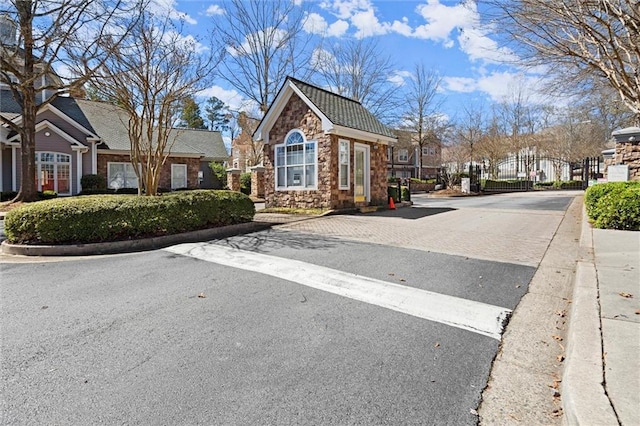 1024 Whitshire Way, Alpharetta, GA 30004 - view of asphalt road featuring curbs, a gate, a gated entry, and a residential view