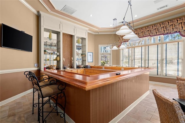 1024 Whitshire Way, Alpharetta, GA 30004 - indoor dry bar with crown molding, light stone finish flooring, hanging light fixtures, a raised ceiling, and recessed lighting