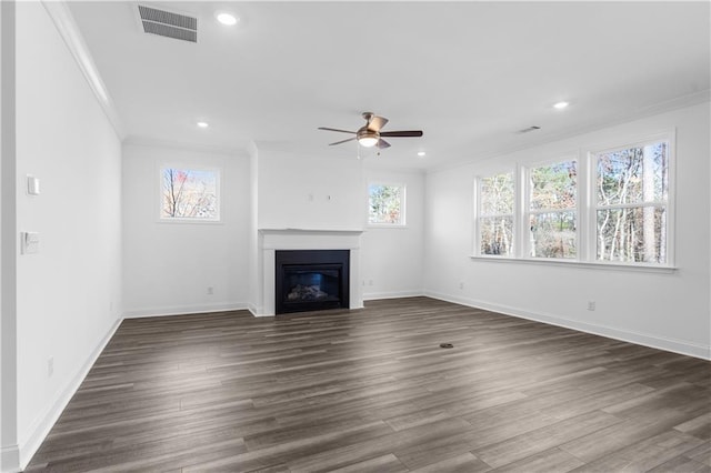 unfurnished living room featuring ceiling fan, ornamental molding, and dark hardwood / wood-style flooring