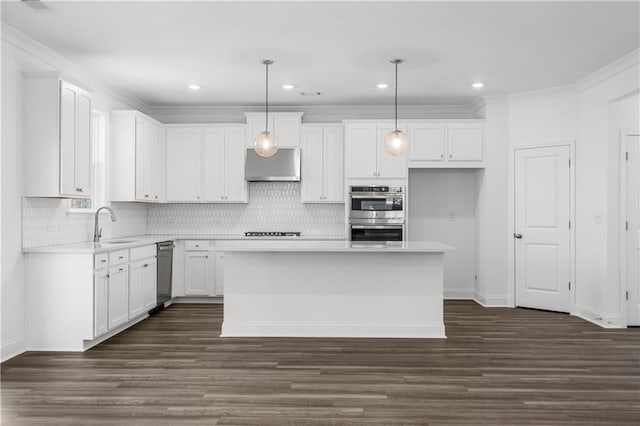 kitchen with pendant lighting, white cabinetry, stainless steel double oven, and a kitchen island