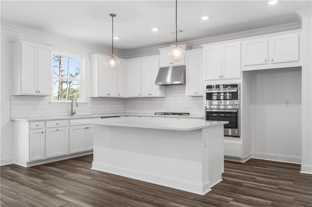 kitchen with a center island, hanging light fixtures, dark hardwood / wood-style flooring, stainless steel double oven, and white cabinets