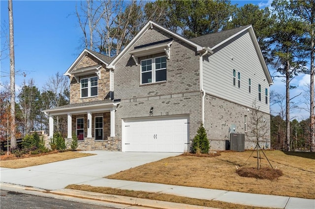 craftsman inspired home with covered porch, a garage, and central air condition unit