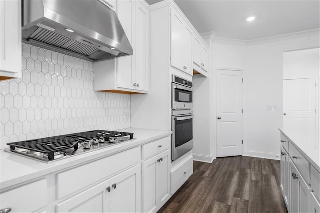 kitchen featuring crown molding, range hood, dark hardwood / wood-style floors, stainless steel appliances, and white cabinets