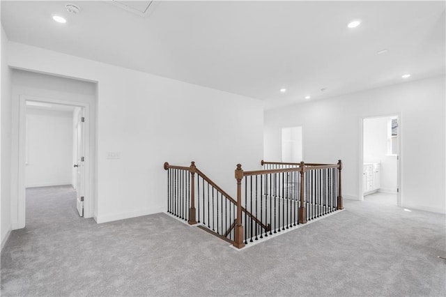 hallway featuring light colored carpet