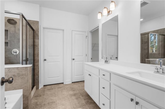 bathroom featuring tile patterned floors, vanity, and plus walk in shower