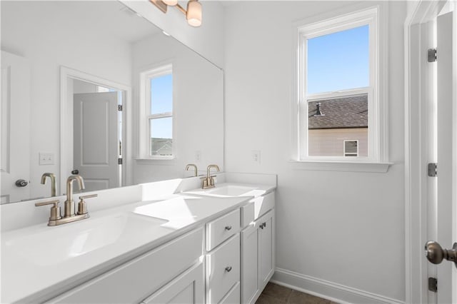 1495 Auburn Glen Rd, Dacula, GA 30019 - bathroom featuring healthy amount of natural light, baseboards, and double vanity
