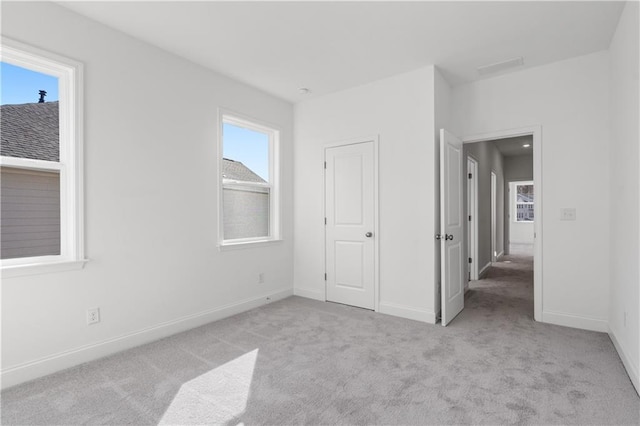 unfurnished bedroom featuring light colored carpet