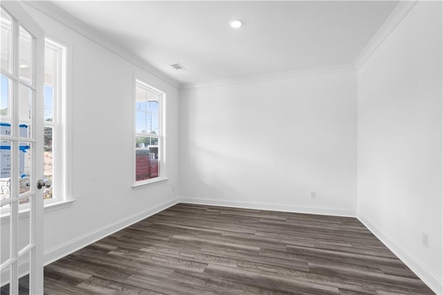 spare room featuring crown molding and dark hardwood / wood-style floors