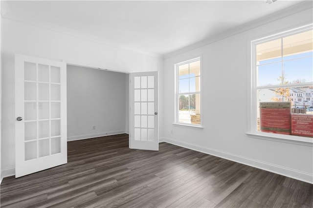 unfurnished room with ornamental molding, dark hardwood / wood-style floors, and french doors