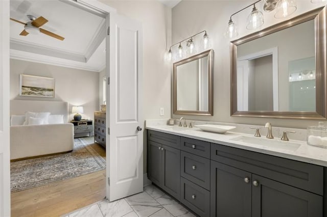 full bathroom with marble finish floor, double vanity, a sink, and crown molding