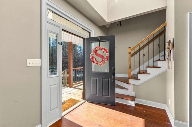 foyer entrance with dark hardwood / wood-style floors and a healthy amount of sunlight