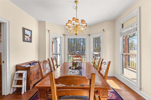 dining area with an inviting chandelier and hardwood / wood-style floors