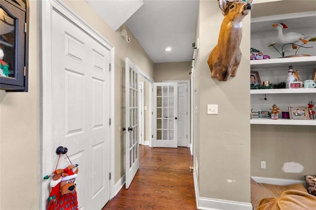 corridor with dark wood-type flooring and french doors