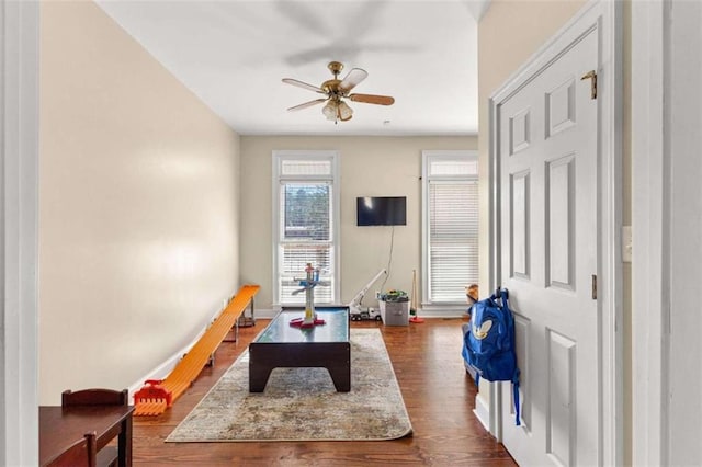 rec room featuring ceiling fan and dark hardwood / wood-style floors