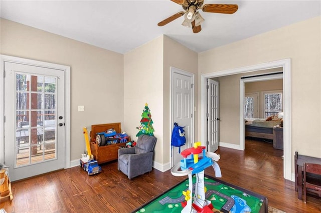 playroom with ceiling fan and wood-type flooring