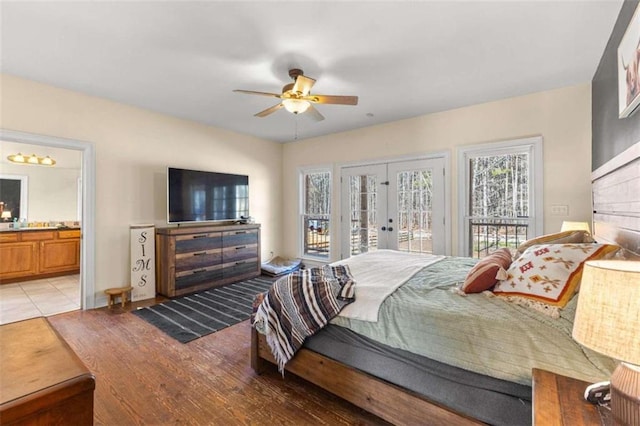 bedroom with ceiling fan, ensuite bath, access to outside, light wood-type flooring, and french doors